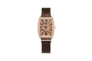 Macro shot of tonneau watch with rose gold diamond case and large Arabic numerals