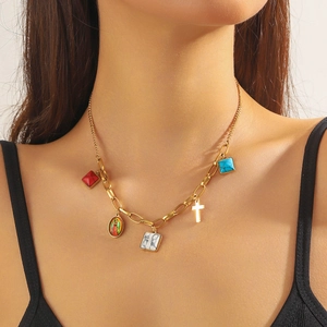 Gold chunky necklace featuring Virgin Mary portrait, turquoise, and colorful charms on model