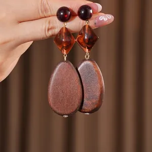 Bohemian geometric wooden earrings with red resin beads and brown drop-shaped pendants