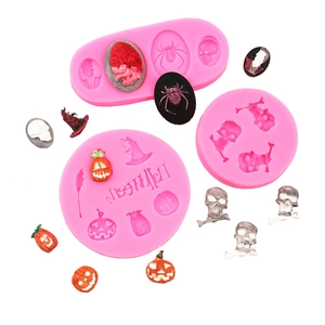 Detail of pink silicone Halloween molds featuring witch, pumpkin and skeleton shapes