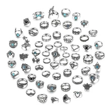 Spiral arrangement of silver rings with turquoise stones in bohemian and vintage styles