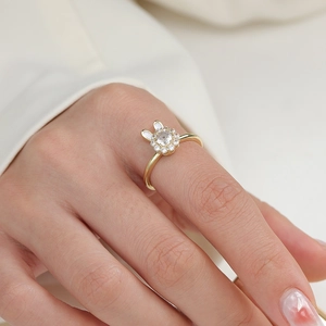 Minimalist spinning rabbit ring in gold with sparkling zircon and white enamel details