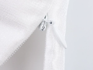 Close-up of white mesh fabric texture and high-quality zipper on the two-piece dress set