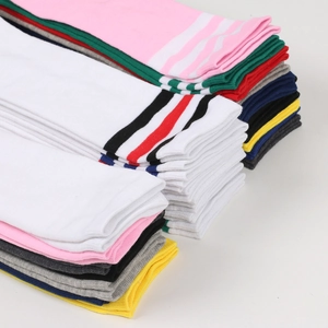 Close-up of colorful striped knee-high socks stacked neatly in diverse vibrant colors