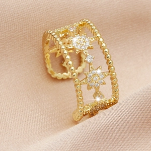 Elegant gold micro-pave zircon star ring with hollowed star design on champagne silk