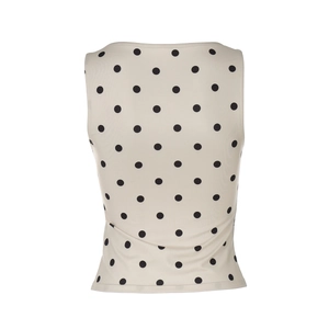 Detailaufnahme des beige Ärmelloses Top mit schwarzen Punkten auf hochwertigem Stoff
