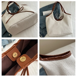 Détail du sac cabas en toile à chevrons avec bordure en cuir et fermoir magnétique
