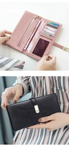 Detail of pink and black long PU leather wallets showing card slots and strap closure