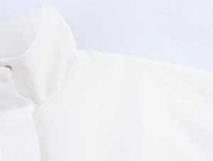 Detailed close-up of a white stand-up collar jacket featuring a silver metal snap button