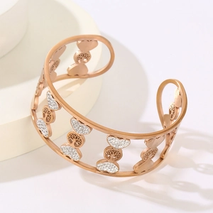 Macro detail of rose gold tree of life cuff bracelet with white crystals inlay