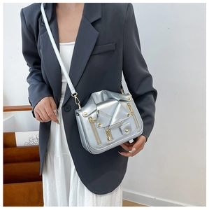 Detail of silver metallic biker jacket shaped crossbody bag with multiple zippers