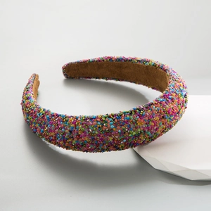 Macro shot of colorful beaded wide headband featuring thick padding and brown velvet lining