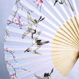 Classical Chinese folding fan featuring crane and plum blossom patterns on bamboo ribs
