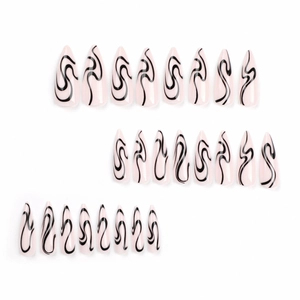 Long stiletto press-on nails with light pink base and black abstract spiral snake pattern