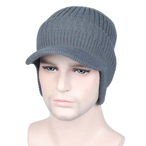 Detail view of a grey knitted winter aviator hat with earflaps on a mannequin head