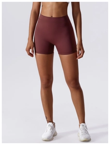 Detail of high-waist seamless waistband on deep burgundy yoga shorts with matte texture