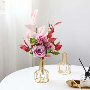Pink roses and chrysanthemums in a gold metal frame glass vase for table decor