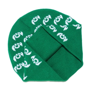 Detailed knit texture of a green winter beanie with white letter jacquard patterns