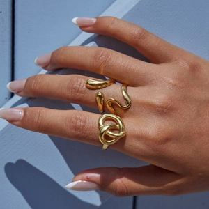 Golden abstract wave and knot rings set in high-quality polished stainless steel