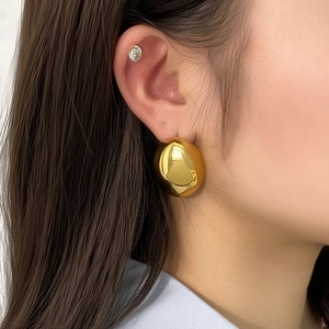 Gepolijste 18K vergulde oversized ovale geometrische oorbellen gedragen door model