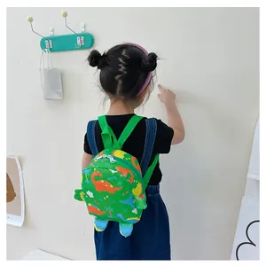 Close-up of lightweight green backpack with cartoon dinosaur prints for toddlers