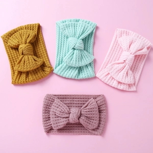 Set of four waffle knit baby headbands with large bows in yellow, green, and pink colors