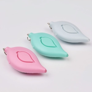 Leaf-shaped personal alarms in pink, mint, and blue with metal keychains on white background