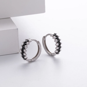 Macro shot of S925 silver hoop earrings with black zircon stones in a gothic punk style