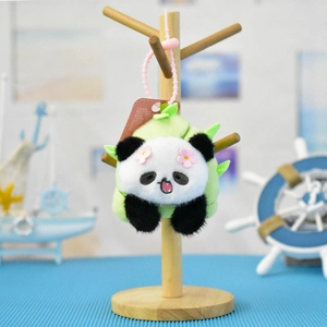 Detailed close-up of a cute panda plush keychain with bamboo shoot design for bags