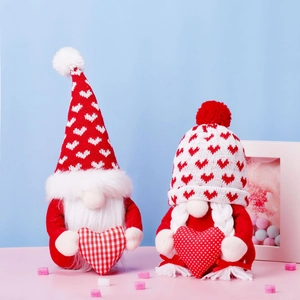 Two red and white Christmas gnomes plush dolls with hearts for festive party decoration