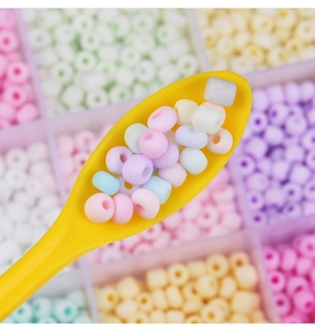 Detailed macro view of 4mm pastel frosted glass seed beads for DIY jewelry making