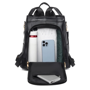 Detail view of large capacity black leather backpack showing interior storage for daily items