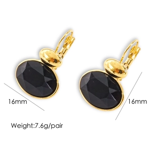 Macro view of oval gold-plated earrings with black faceted gemstones and size details