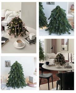 Detail of mini artificial Christmas tree with pink ribbons and warm LED string lights decor