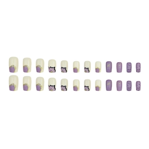 Purple and cream glitter press-on nails with gold foil and abstract wavy patterns