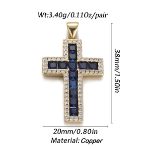 Macro view of gold cross pendant with dark blue stone and cubic zirconia inlay