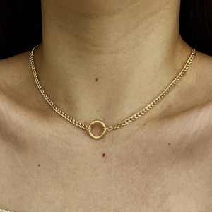 Close-up of 18K gold plated necklace with colorful zircon pendant on woman's neck