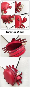 Detail view of red crab coin purse featuring lychee grain texture and metal zipper