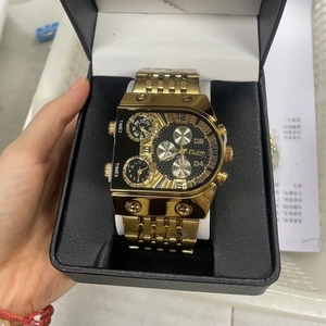 Detailed view of Oulm multi-timezone gold watch featuring three dials in a gift box