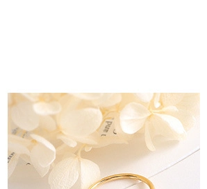 Detailed view of minimalist polished gold ring band with a smooth mirror finish