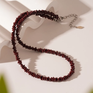 Vintage stainless steel choker with deep red irregular beads on white artistic stone