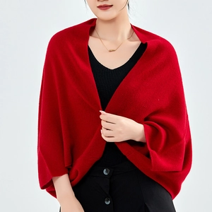 Cozy red cashmere knit shawl wrap and cardigan for women in a professional studio shot