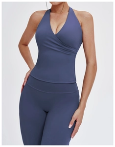 Detail of V-neck halter yoga top and high-waist leggings in matte navy blue fabric