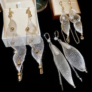 Elegant gold drop earrings with pearl mesh tassels and silver needles in luxury style