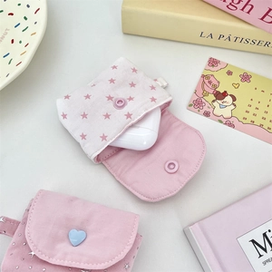 Detail view of star pattern canvas earphone pouch with decorative heart button
