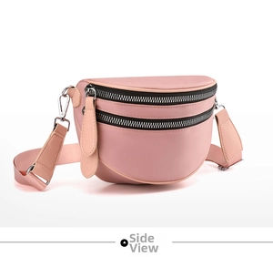 Detailed side view of pink crossbody bag featuring dual zippers and adjustable fabric strap