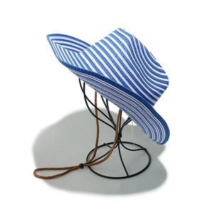 Detailed close-up of blue and white striped straw sun hat with woven chin strap and bead