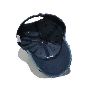 Detail view of cotton baseball cap interior with moisture sweatband and metal buckle