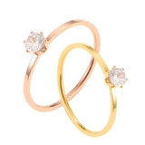 Macro detail of minimalist rose gold and gold rings with round brilliant-cut diamonds