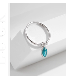Detailed macro of S925 sterling silver ring with mint green marquise gemstone charm